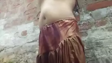 Village girl having open bath